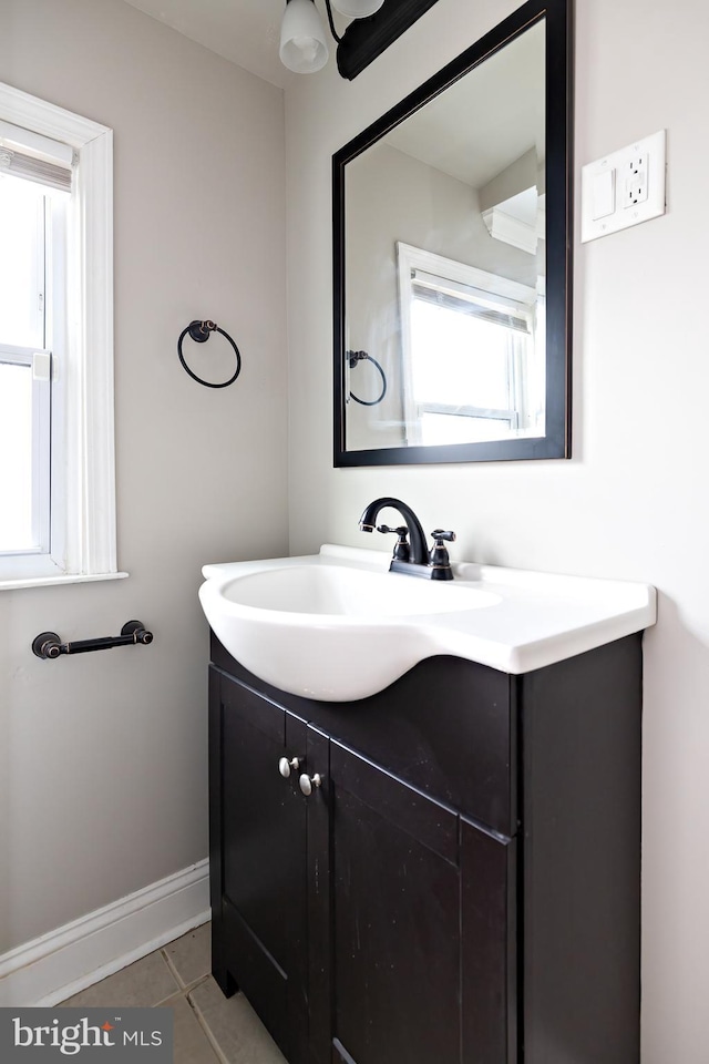 bathroom featuring tile patterned flooring, vanity, and baseboards