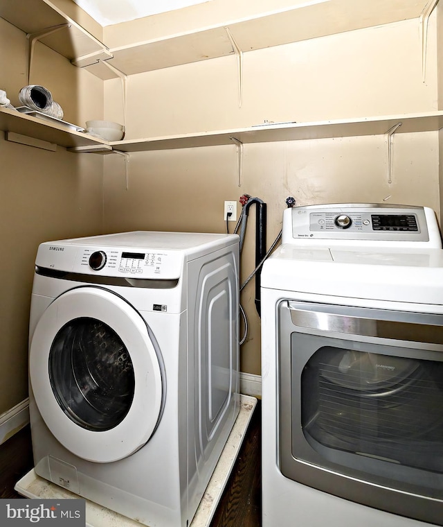 clothes washing area featuring laundry area and washing machine and clothes dryer