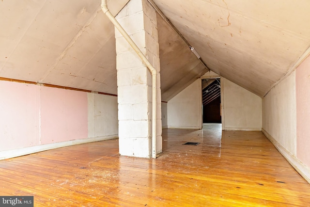 additional living space with lofted ceiling and wood-type flooring