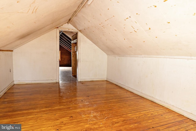 bonus room featuring vaulted ceiling and hardwood / wood-style floors