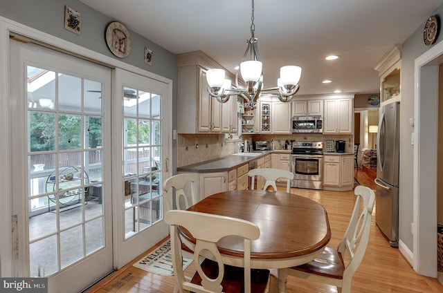 dining space with light wood-type flooring, visible vents, a notable chandelier, and recessed lighting