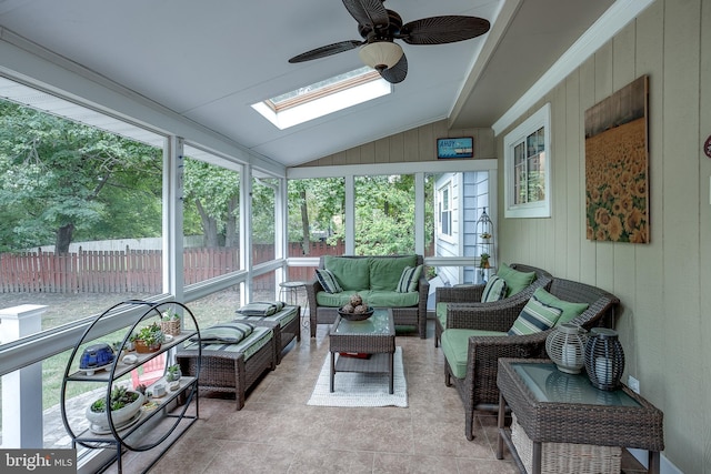 sunroom / solarium featuring lofted ceiling with skylight and a ceiling fan