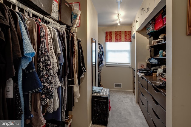 walk in closet with light carpet and visible vents