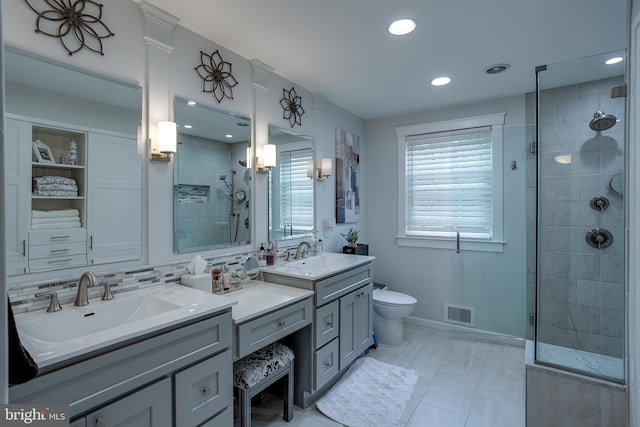 bathroom with toilet, recessed lighting, vanity, visible vents, and a shower stall