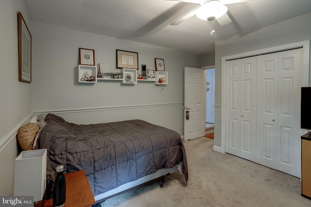 carpeted bedroom with a closet and ceiling fan