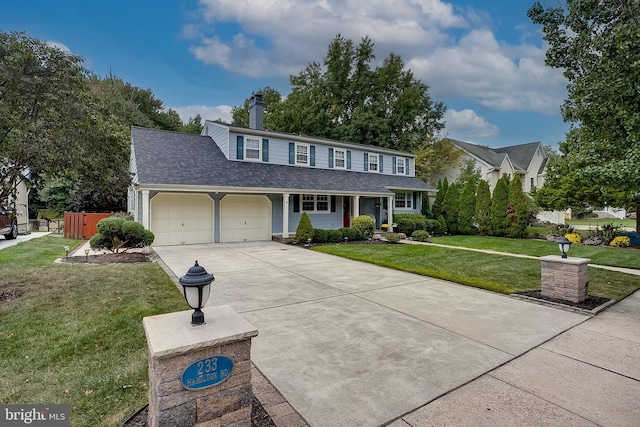 view of front of house with a shingled roof, a front yard, fence, a garage, and driveway