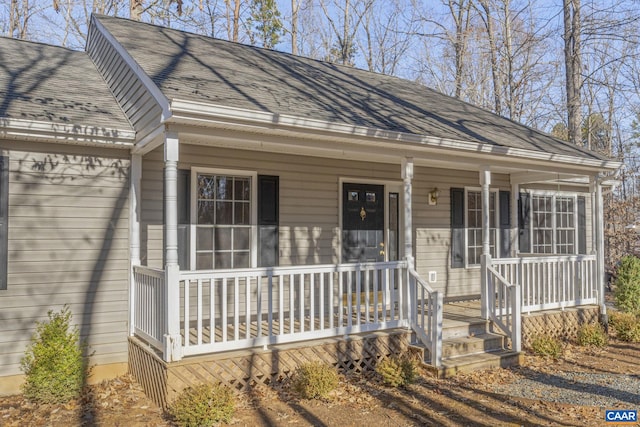 view of front of home featuring covered porch and a shingled roof