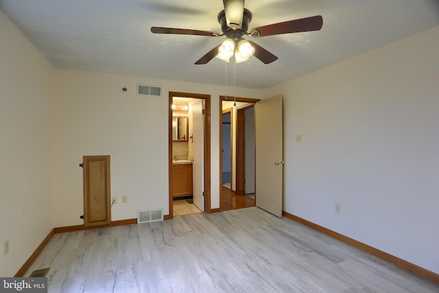 unfurnished bedroom featuring light wood-style flooring, visible vents, and baseboards