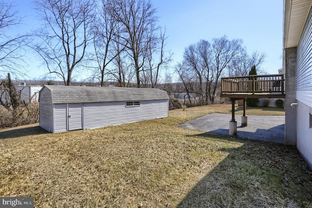 view of yard with a patio area, a storage unit, a deck, and an outdoor structure