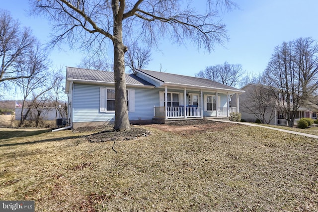 ranch-style house featuring covered porch and metal roof