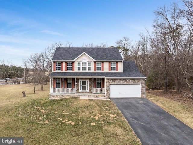 view of front facade featuring a porch, a shingled roof, stone siding, driveway, and a front lawn