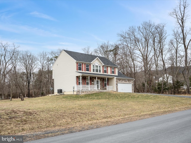 view of front of house with a front lawn, covered porch, central AC, and an attached garage