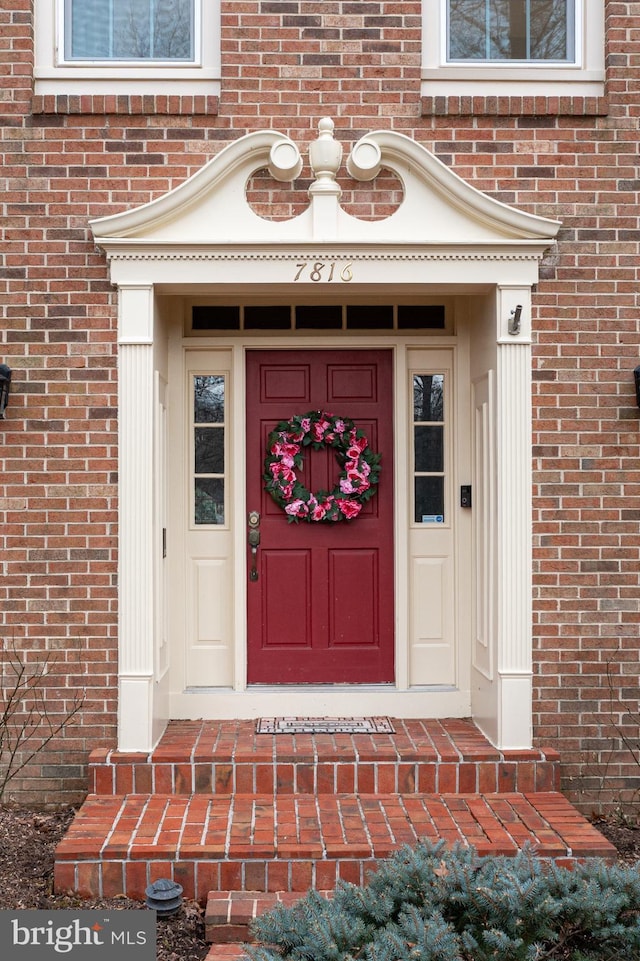 property entrance with brick siding