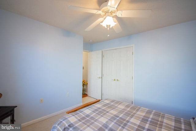 bedroom with a ceiling fan, a closet, carpet floors, and baseboards