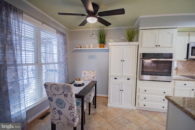 kitchen with appliances with stainless steel finishes, visible vents, ornamental molding, and white cabinetry