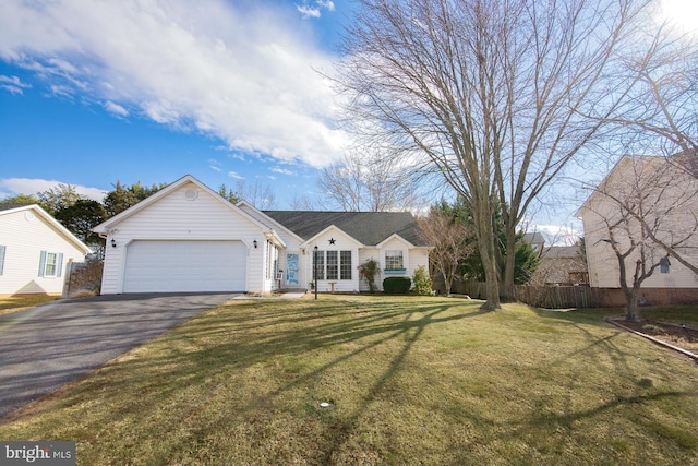 view of front facade featuring an attached garage, fence, aphalt driveway, and a front yard