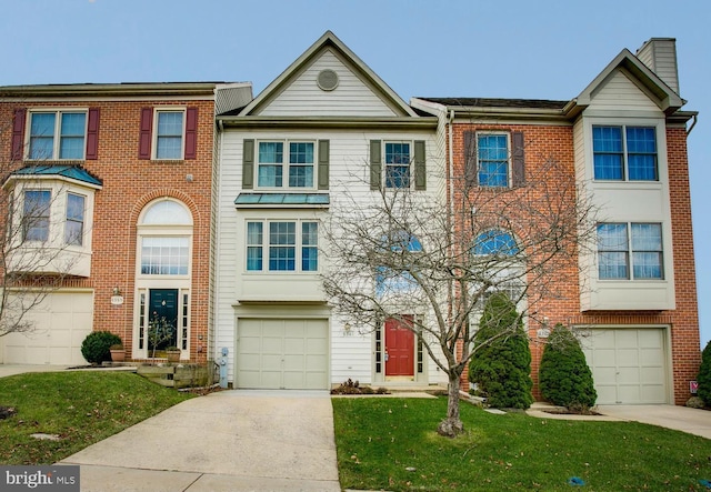 townhome / multi-family property with a garage, brick siding, concrete driveway, and a front yard