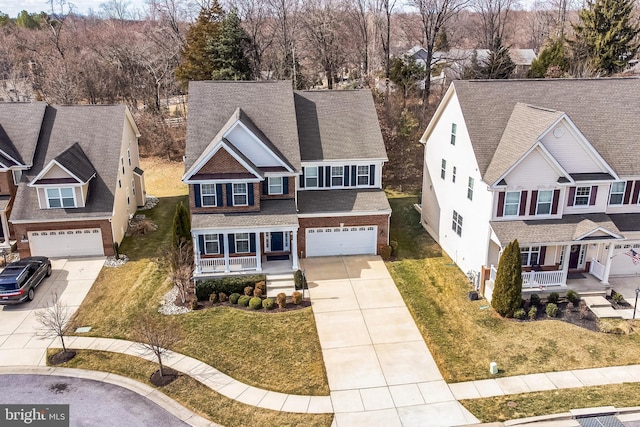 view of front of property featuring a garage, driveway, a porch, and brick siding