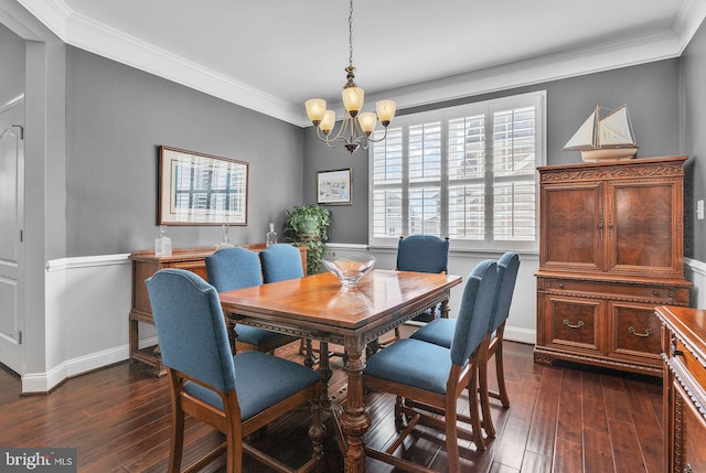 dining room with an inviting chandelier, baseboards, ornamental molding, and dark wood finished floors