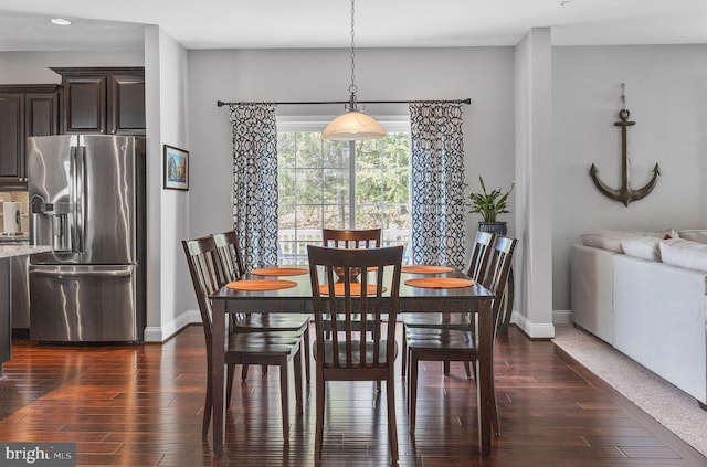 dining space with dark wood-style floors and baseboards