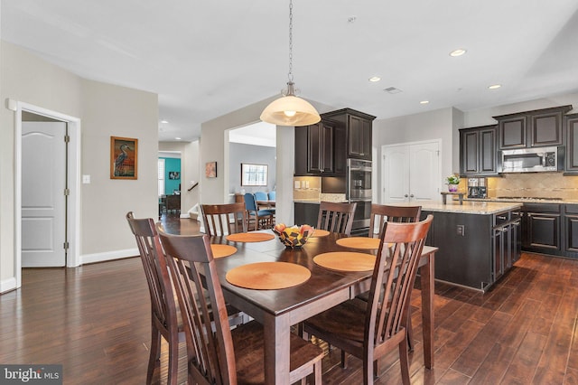 dining room with recessed lighting, dark wood-style flooring, and baseboards