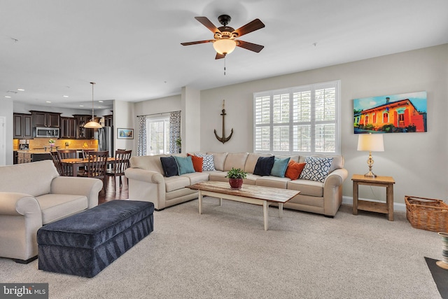 living room with light carpet, ceiling fan, baseboards, and recessed lighting