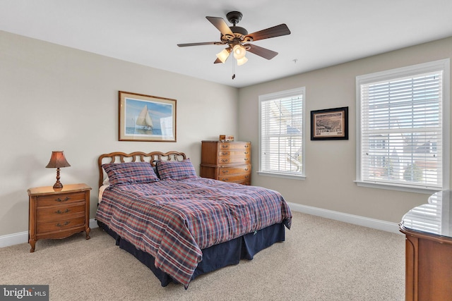 carpeted bedroom featuring a ceiling fan and baseboards