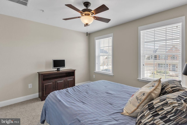 bedroom with a ceiling fan, carpet, visible vents, and baseboards