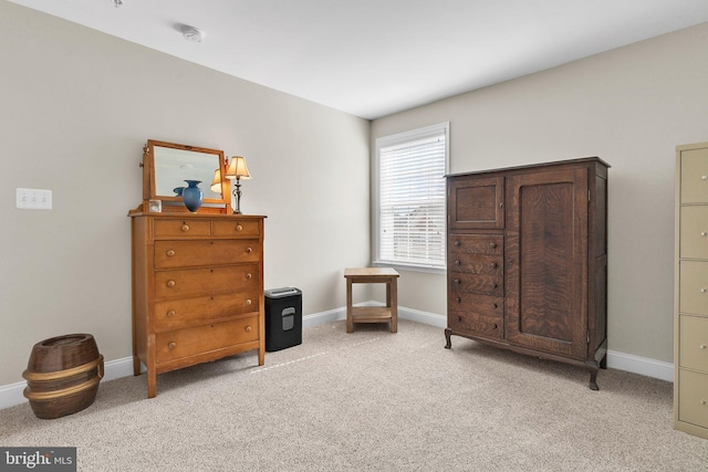 living area with light carpet and baseboards