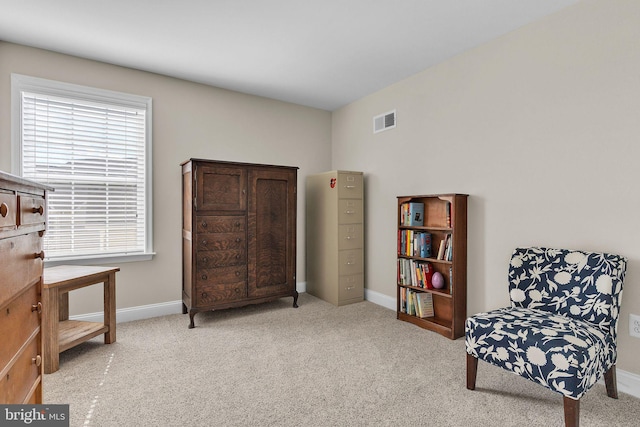 sitting room with baseboards, visible vents, and carpet flooring