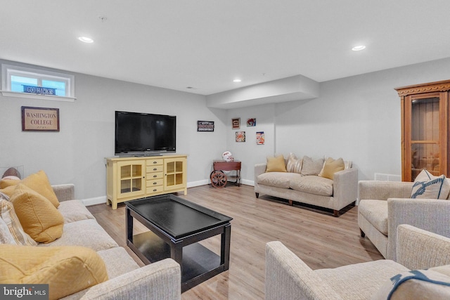 living room featuring baseboards, visible vents, light wood-style flooring, and recessed lighting