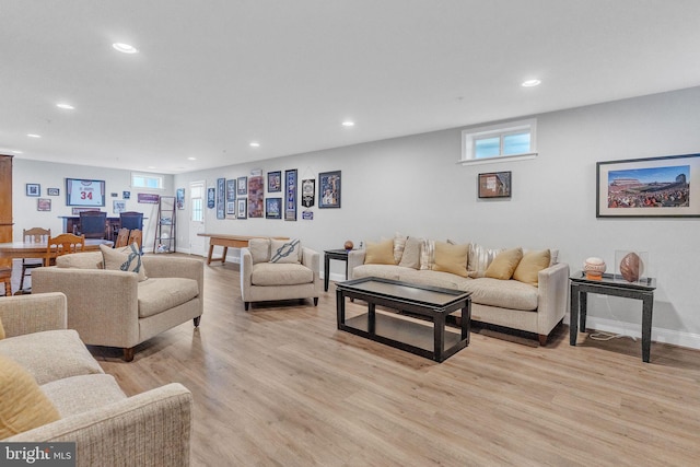 living area with recessed lighting, baseboards, and light wood finished floors