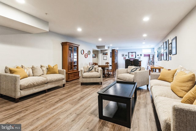 living room featuring light wood-style flooring and recessed lighting