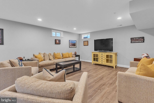 living room with light wood-style floors, visible vents, baseboards, and recessed lighting