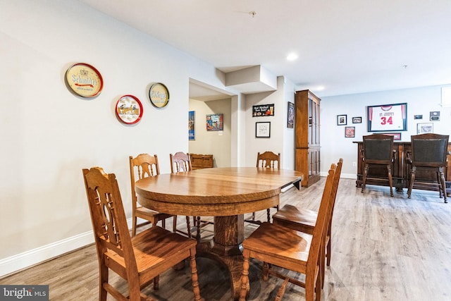 dining room with light wood-style flooring and baseboards