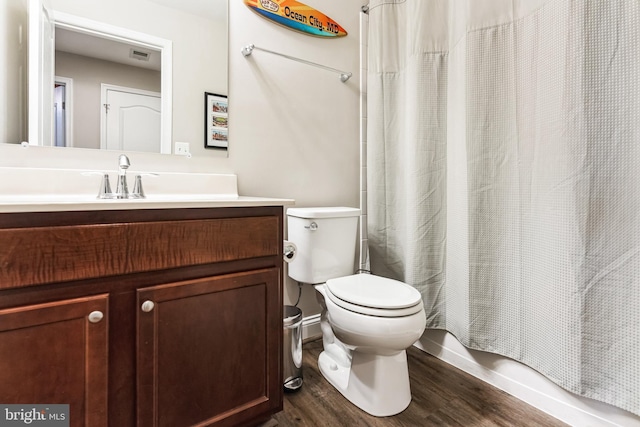 full bathroom featuring toilet, visible vents, wood finished floors, and vanity