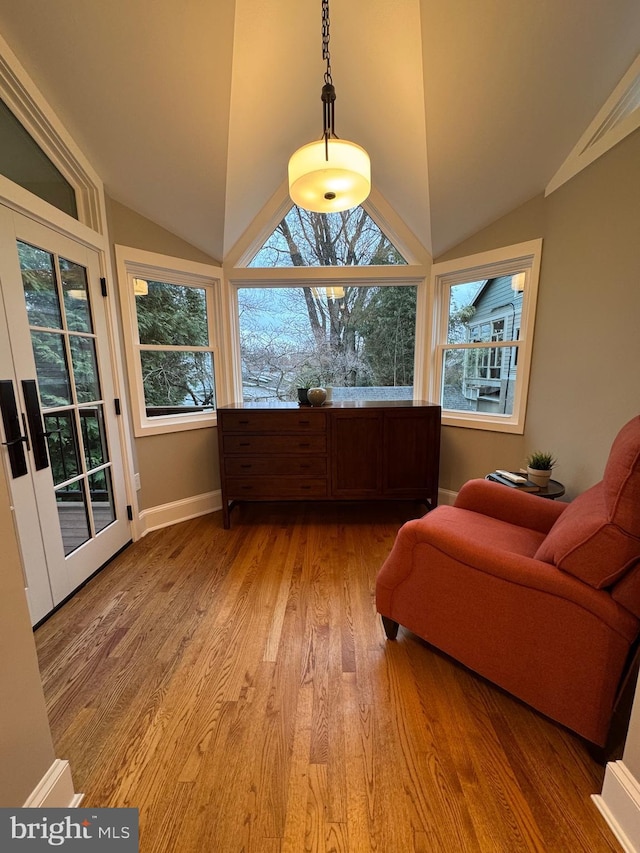 sunroom / solarium with vaulted ceiling and a healthy amount of sunlight