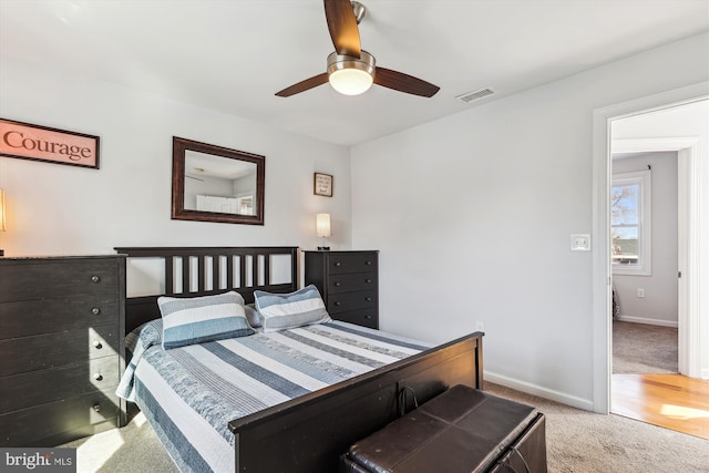 bedroom featuring a ceiling fan, carpet flooring, baseboards, and visible vents