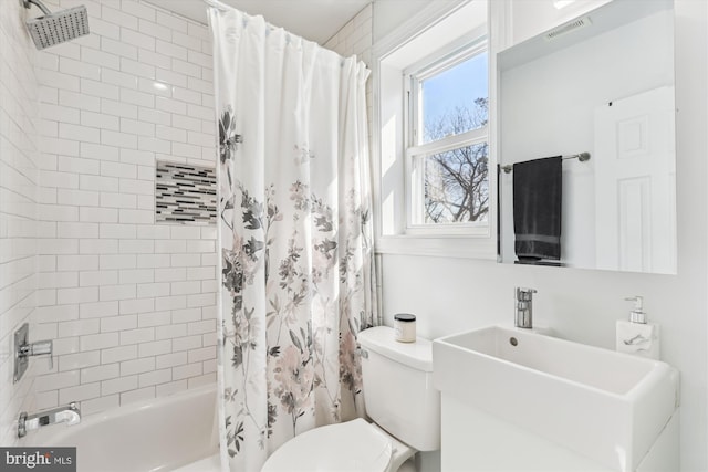 bathroom with toilet, shower / bathtub combination with curtain, visible vents, and a sink