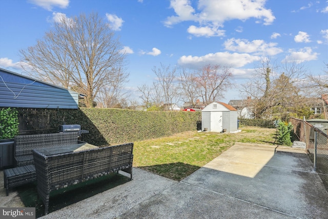 view of yard featuring a storage shed, a patio, an outbuilding, and a fenced backyard