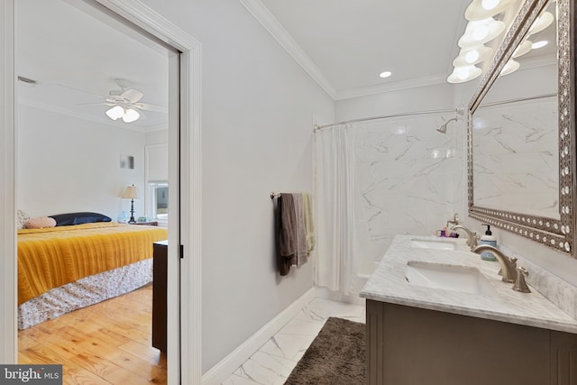 bathroom featuring marble finish floor, ensuite bath, ornamental molding, and a sink