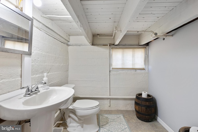 bathroom with baseboards, beam ceiling, a sink, wood ceiling, and toilet