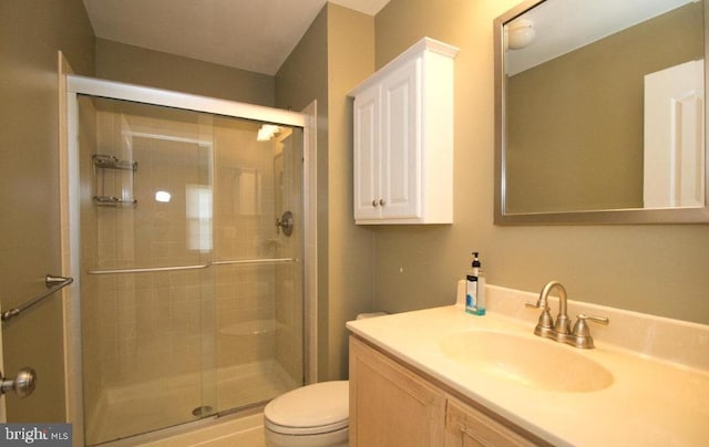 full bathroom with a shower stall, toilet, and vanity