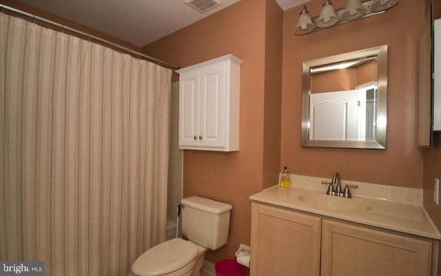 full bathroom with visible vents, vanity, and toilet