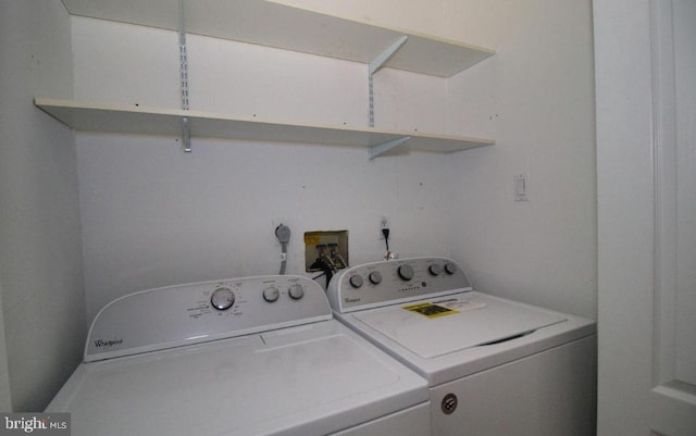 clothes washing area with laundry area and washer and dryer