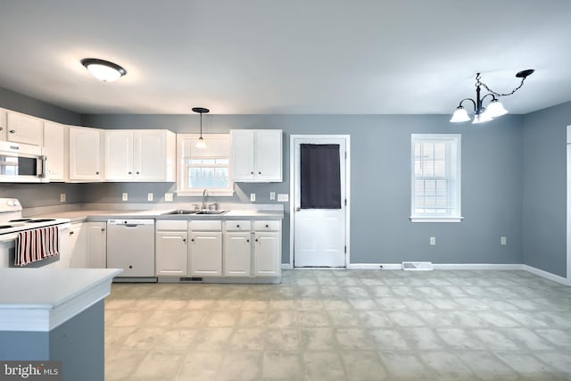 kitchen with light floors, visible vents, white cabinets, a sink, and white appliances