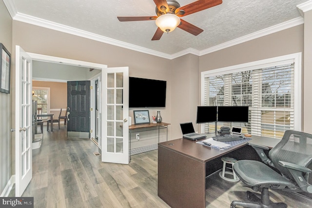 office space with ornamental molding, wood finished floors, ceiling fan, a textured ceiling, and french doors