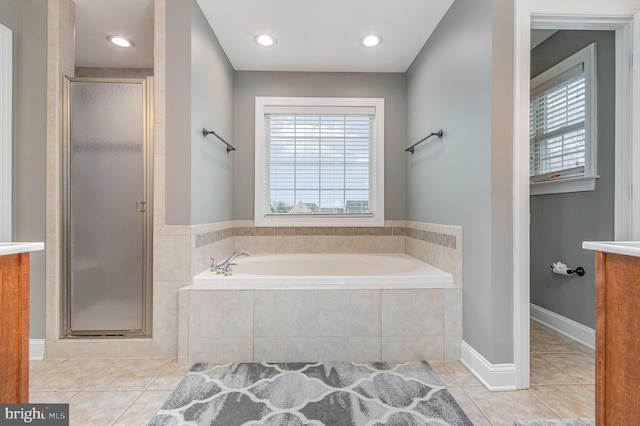 full bathroom with a healthy amount of sunlight, tile patterned flooring, a shower stall, and a bath