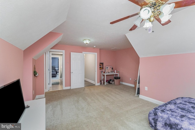 carpeted bedroom with ceiling fan, vaulted ceiling, and baseboards