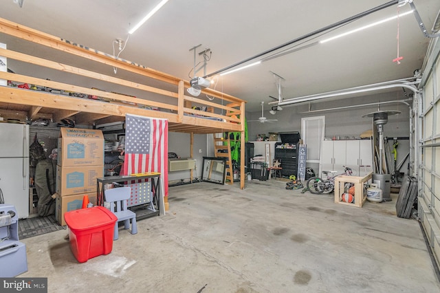 garage with freestanding refrigerator and a garage door opener